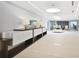 Bright hallway with decorative lamps, a sleek console, and tile floors leading to a seating area at 3325 Piedmont Ne Rd # 2501, Atlanta, GA 30305