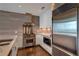Modern kitchen with stainless steel appliances, gray tile backsplash, and light wood flooring at 3325 Piedmont Ne Rd # 2501, Atlanta, GA 30305
