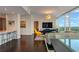 Bright open-concept living and dining area with city skyline views and wood flooring at 3325 Piedmont Ne Rd # 2501, Atlanta, GA 30305