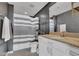 Modern bathroom features a granite vanity, a shower with gray striped curtain, and neutral tones at 361 17Th St # 1121, Atlanta, GA 30363