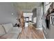 A cozy living room featuring hardwood floors, grey walls, and an open layout connected to the modern kitchen at 361 17Th St # 1121, Atlanta, GA 30363