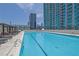 Beautiful rooftop pool with lounge chairs offers a refreshing escape with stunning city views at 361 17Th St # 1121, Atlanta, GA 30363