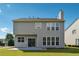 Back of house with a patio area and manicured lawn, perfect for outdoor enjoyment at 8965 Friarbridge Dr, Suwanee, GA 30024