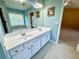 Bright bathroom with dual sinks, a wide mirror, white cabinetry, and tile flooring at 8965 Friarbridge Dr, Suwanee, GA 30024