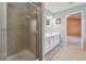 Bathroom with a glass-enclosed shower and a double sink vanity at 8965 Friarbridge Dr, Suwanee, GA 30024