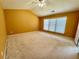 Large bedroom with vaulted ceilings, neutral carpet, and ample natural light from a window at 8965 Friarbridge Dr, Suwanee, GA 30024