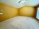 Spacious bedroom with neutral carpet, vaulted ceilings, and a window providing natural light at 8965 Friarbridge Dr, Suwanee, GA 30024