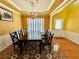 Formal dining room features a decorative ceiling, chandelier, and large table with seating for six at 8965 Friarbridge Dr, Suwanee, GA 30024