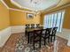 Formal dining room features a decorative ceiling medallion, chandelier, and large window at 8965 Friarbridge Dr, Suwanee, GA 30024