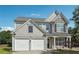 Beautiful two-story home featuring stone accents, a two-car garage, and a well-maintained lawn at 8965 Friarbridge Dr, Suwanee, GA 30024