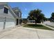 Charming home featuring grey siding, a covered front porch, and an attached two-car garage at 8965 Friarbridge Dr, Suwanee, GA 30024