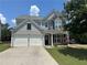 Charming two-story home featuring a two-car garage and a stone-accented facade at 8965 Friarbridge Dr, Suwanee, GA 30024