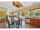 Eat-in kitchen with a table and chairs and a view to the living room and outdoor space at 8965 Friarbridge Dr, Suwanee, GA 30024