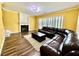 Cozy living room with wood floors, a fireplace, and a comfortable leather sofa at 8965 Friarbridge Dr, Suwanee, GA 30024