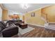 Inviting living room showing staircase, wood floors, and view into the eat-in kitchen at 8965 Friarbridge Dr, Suwanee, GA 30024