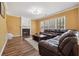 Comfortable living room with hardwood floors, fireplace, and large window at 8965 Friarbridge Dr, Suwanee, GA 30024