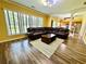 Open-concept living room with wood flooring, fireplace, and view to the kitchen at 8965 Friarbridge Dr, Suwanee, GA 30024