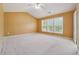 Spacious main bedroom with vaulted ceilings, carpet flooring, and a large window at 8965 Friarbridge Dr, Suwanee, GA 30024