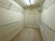 Empty walk-in closet with adjustable wire shelving on all walls at 8965 Friarbridge Dr, Suwanee, GA 30024