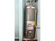 Image of a Rheem gas water heater with visible connections and energy guide label at 8965 Friarbridge Dr, Suwanee, GA 30024