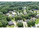 Expansive aerial shot of a lush, green neighborhood showcasing numerous homes nestled among mature trees at 1024 Cromwell Pt, Snellville, GA 30078