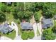 A bird's-eye view of neatly landscaped homes with driveways in a residential community, surrounded by trees and greenery at 1024 Cromwell Pt, Snellville, GA 30078
