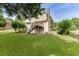Well-kept backyard showcasing a green lawn, mature trees, and the home's rear exterior with deck at 1024 Cromwell Pt, Snellville, GA 30078