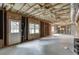 Unfinished basement with insulation, exposed beams, concrete floor, and an exterior door at 1024 Cromwell Pt, Snellville, GA 30078