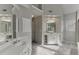 Bright bathroom boasting a double vanity with white cabinets, carpet flooring and modern fixtures at 1024 Cromwell Pt, Snellville, GA 30078