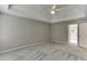 Bedroom featuring a tray ceiling, ceiling fan and a view to a bathroom at 1024 Cromwell Pt, Snellville, GA 30078