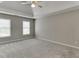 Bright bedroom featuring two windows and a ceiling fan at 1024 Cromwell Pt, Snellville, GA 30078