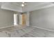Bedroom featuring a tray ceiling, ceiling fan and neutral color palette at 1024 Cromwell Pt, Snellville, GA 30078