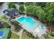 A large swimming pool with an adjacent kiddie pool, lounge chairs, and shade structures in a community setting at 1024 Cromwell Pt, Snellville, GA 30078