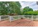 Spacious wooden deck with white railings overlooking the lush, green backyard at 1024 Cromwell Pt, Snellville, GA 30078
