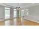 Open-concept dining room featuring hardwood floors, large windows, and an archway leading to the foyer at 1024 Cromwell Pt, Snellville, GA 30078
