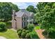 Charming two-story brick home with lush landscaping, offering a serene and inviting curb appeal at 1024 Cromwell Pt, Snellville, GA 30078