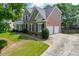 Stunning brick two-story home featuring a two-car garage and a beautifully manicured lawn at 1024 Cromwell Pt, Snellville, GA 30078