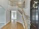 Grand foyer with hardwood floors, a staircase with white railings, and a view into the adjacent living space at 1024 Cromwell Pt, Snellville, GA 30078