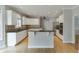 Spacious kitchen has a center island with granite countertop and modern appliances at 1024 Cromwell Pt, Snellville, GA 30078