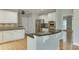 Well-lit kitchen featuring white cabinets, granite countertops, and stainless steel appliances at 1024 Cromwell Pt, Snellville, GA 30078