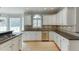 Bright kitchen featuring white cabinets, granite countertops, and stainless steel appliances at 1024 Cromwell Pt, Snellville, GA 30078