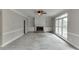 Bright living room featuring a fireplace, built-in bookshelves, and large windows at 1024 Cromwell Pt, Snellville, GA 30078