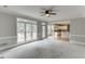 Large living room with big windows, kitchen access, and back deck access at 1024 Cromwell Pt, Snellville, GA 30078