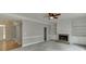 Spacious living room featuring a ceiling fan, fireplace, and custom built-in shelving at 1024 Cromwell Pt, Snellville, GA 30078