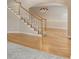 Spacious room with hardwood floors and stairs leading to the upper level, showcasing a decorative chandelier at 1024 Cromwell Pt, Snellville, GA 30078