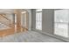 Inviting living room with hardwood floors, large windows, and an arched doorway leading to the front entryway at 1024 Cromwell Pt, Snellville, GA 30078