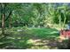 Large backyard featuring mature trees and ample green space for outdoor activities and entertaining at 2619 Old Toney Rd, Ellenwood, GA 30294