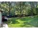 View of the backyard, showing the lush lawn and surrounding trees offering privacy at 2619 Old Toney Rd, Ellenwood, GA 30294