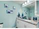 Bright bathroom features granite countertops, vanity, sink, mirror, and decor at 2619 Old Toney Rd, Ellenwood, GA 30294