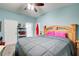Cozy bedroom features a ceiling fan, ensuite bathroom, and a large bed with a wooden headboard at 2619 Old Toney Rd, Ellenwood, GA 30294